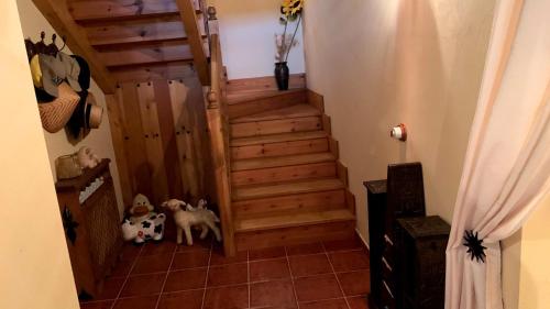 a staircase in a home with a wooden stair case at La Puerta de Gredos in San Martín del Pimpollar