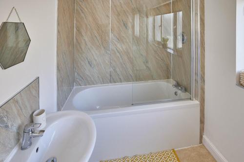 a bathroom with a white tub and a sink at Host & Stay - 1 Oswy Street in Whitby