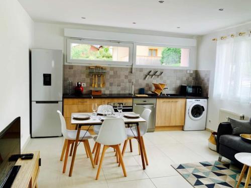 a kitchen and living room with a table and chairs at LE "PETIT GERVAIS" pour un instant parfait ! in Saint-Gervais-les-Bains