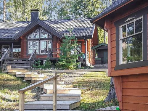 a log cabin with a staircase in front of it at Holiday Home Puolen hehtaarin metsä by Interhome in Haapaniemi