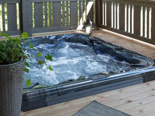 a hot tub on a deck with a plant at Holiday Home Kivipirtti by Interhome in Keuruu