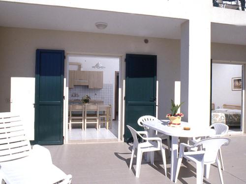 a dining room and kitchen with a table and chairs at Apartment Albatros-1 by Interhome in Caorle