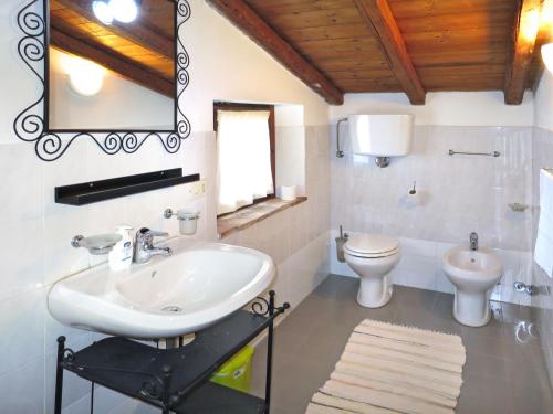 a bathroom with a sink and a toilet at Holiday Home Ginestre 4 by Interhome in Santo