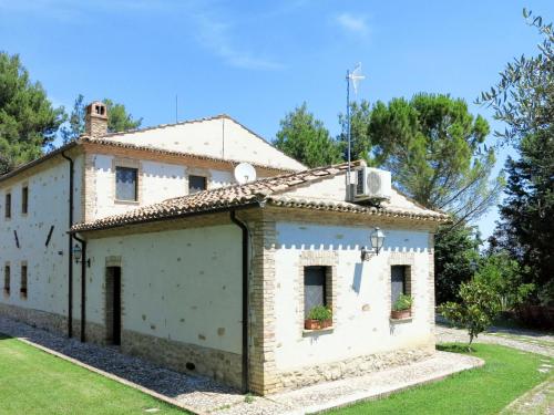 an old building in a yard with trees at Holiday Home Il Noceto by Interhome in Penne