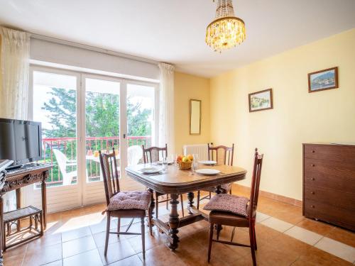 a dining room with a table and chairs and a television at Apartment Toki Maïtena by Interhome in Bidart