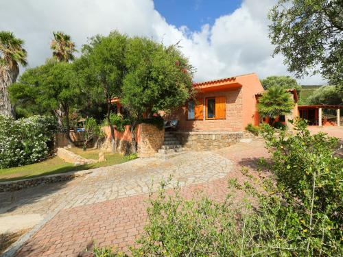 a house with a brick driveway in front of it at Villa Bouganville by Interhome in Badesi