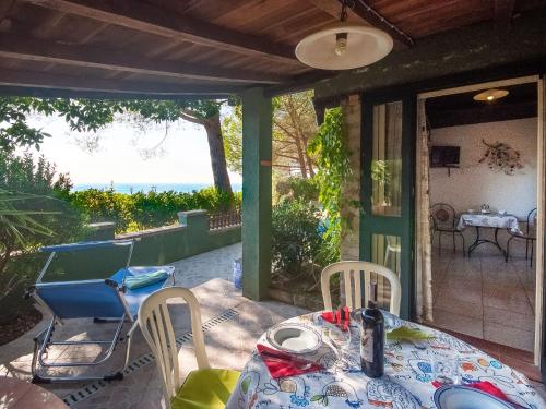 a table and chairs on the porch of a house at Holiday Home Piccola Oasi 6 by Interhome in Casa Ajali