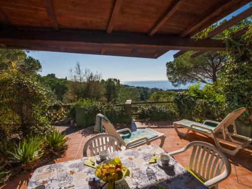 a patio with a table and chairs with a view at Holiday Home Piccola Oasi 4 by Interhome in Capoliveri
