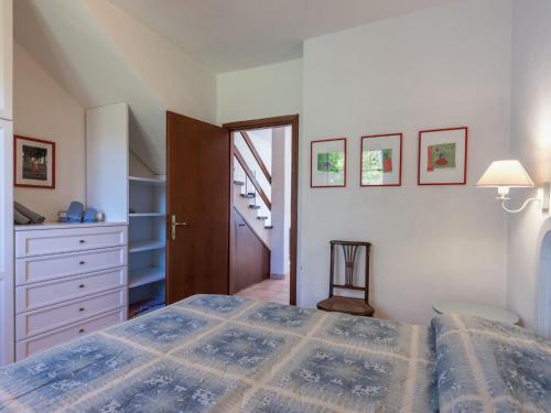 a bedroom with a large bed and a staircase at Holiday Home Querceto by Interhome in Sassofortino