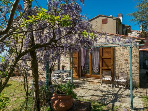 dom z kwitnącym drzewem przed nim w obiekcie Holiday Home La Casetta by Interhome w mieście Sassofortino
