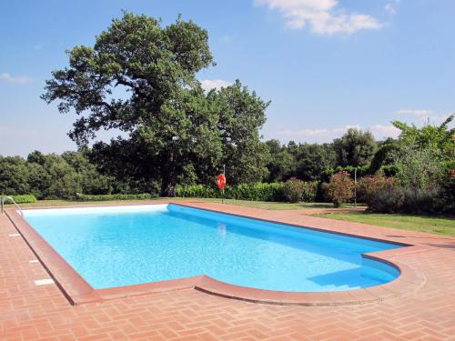 a large swimming pool in a yard with trees at Holiday Home Boriano-3 by Interhome in Lubriano
