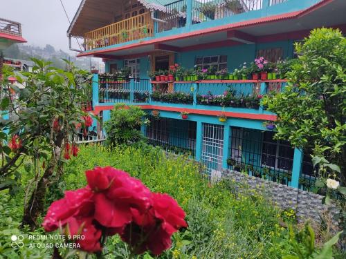 a building with flowers in front of it at Kabiraalaya Homestay in Darjeeling