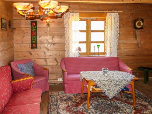 a living room with a couch and a table at Holiday Home Rabbane by Interhome in Nyttingsnes