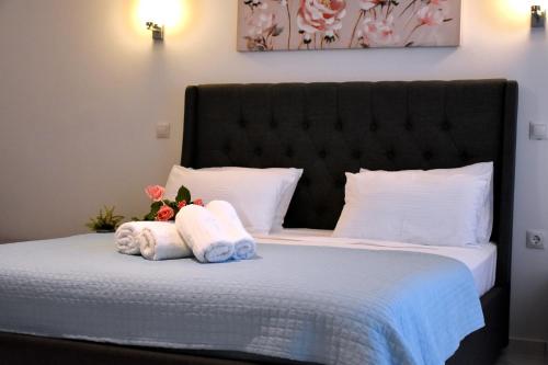 a bedroom with a bed with towels on it at The Blue Rooms in Áyioi Apóstoloi