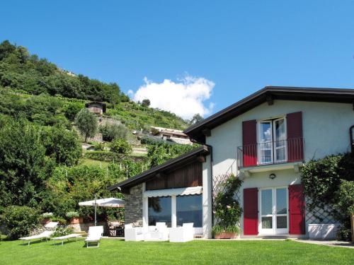 a house on a hill with a grass yard at Holiday Home Gabriella by Interhome in Domaso