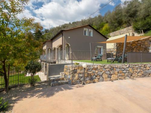 a stone wall in front of a house at Apartment Casa Mimosa by Interhome in Pontedassio