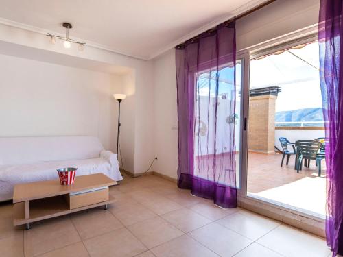 a bedroom with a bed and a sliding glass door at Apartment Frontal Montañas by Interhome in Oropesa del Mar