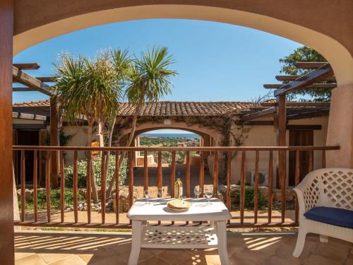 un patio con una mesa blanca y una valla en Holiday Home Acacia 3 - Vista Village by Interhome, en Porto San Paolo
