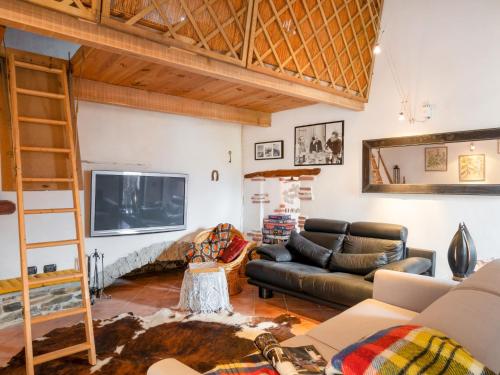 a living room with a couch and a tv at Holiday Home Carametto by Interhome in Andagna