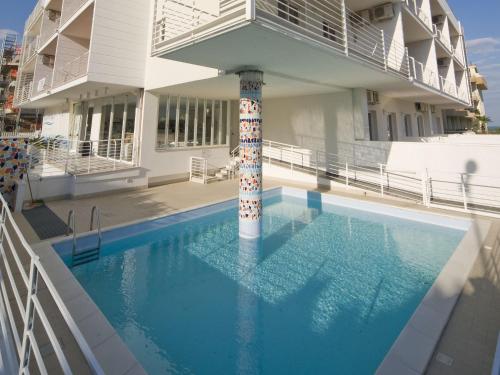 a swimming pool with a column in front of a building at Apartment Rosburgo-4 by Interhome in Roseto degli Abruzzi