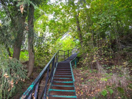 a set of stairs in a forest with trees at Holiday Home Neznašov by Interhome in Neznašov