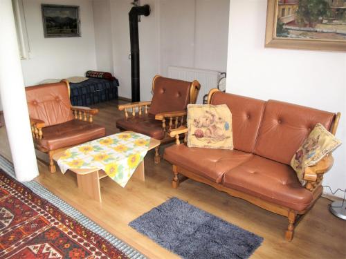 a living room with brown leather furniture and a couch at Holiday Home Neznašov by Interhome in Neznašov