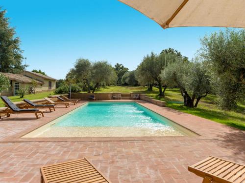 einen Pool mit Bänken und Bäumen im Hof in der Unterkunft Apartment L'Essiccatoio-2 by Interhome in Bolsena