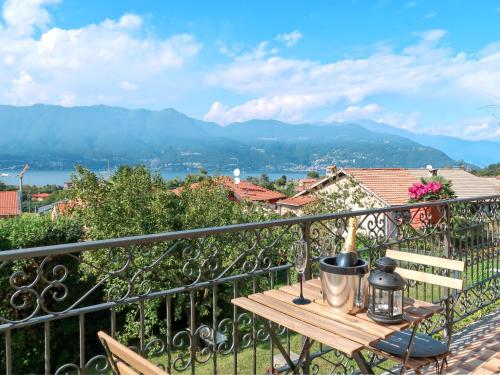 a table on a balcony with a view of the mountains at Holiday Home di Elsa by Interhome in Brezzo