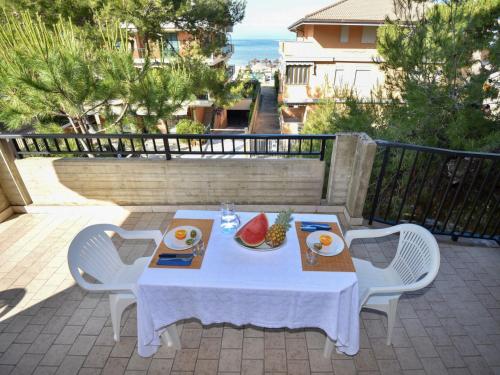 einen Tisch mit einem Teller Essen auf einer Terrasse in der Unterkunft Studio Adriatico-1 by Interhome in San Silvestro