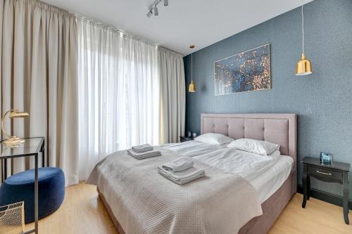 a bedroom with a large bed with two towels on it at Dom & House - Apartments Old Town Tartaczna in Gdańsk