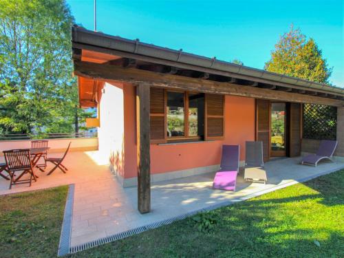 a house with chairs and a patio at Holiday Home Daniela by Interhome in Luino