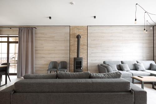 a living room with a couch and a fireplace at Mountain Residence Apartments & Chalet in Bukovel
