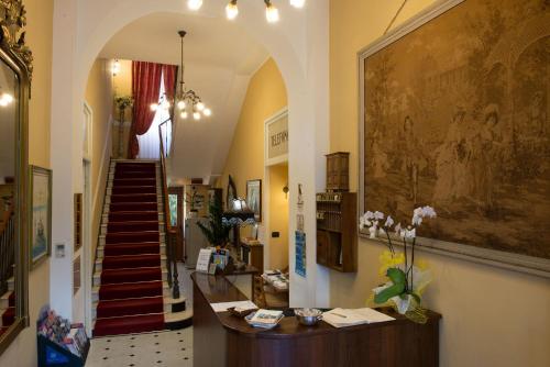a hallway with a staircase in a building at Hotel Belle Epoque in Sanremo