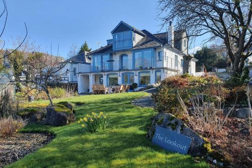 a large white house with a sign in the yard at The Lookout Keswick in Keswick