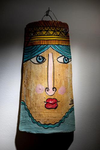 a painting of a face on a wall at Trapani Home in Trapani