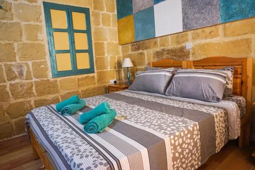 a bedroom with two beds with towels on them at Ta' Lorenzo Farmhouse in San Lawrenz