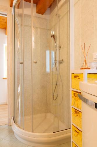 a shower with a glass door in a bathroom at Albergo Diffuso Polcenigo C. Zoldan in Polcenigo