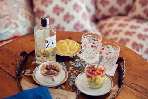 a table with a bowl of fruit and a bottle of water at Cristine Bedfor Mahon in Mahón