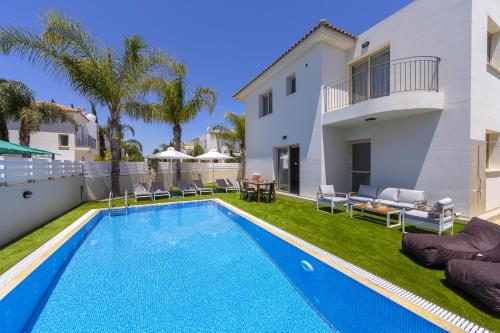a swimming pool in the backyard of a villa at Protaras Palm Villa 54 in Protaras