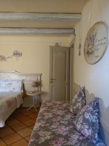 a bedroom with a bed and a clock on the wall at B&B Casa Camilla in Padova