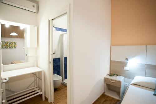 a bathroom with a sink and a toilet and a mirror at Trapani Home in Trapani