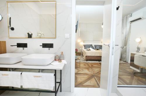 a bathroom with two sinks and a living room at Garden Luxury Room in Split