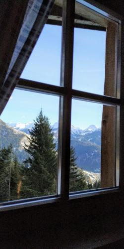 a window with a view of a mountain view at Le Bifore in valle in Predazzo