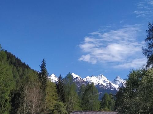 a view of a mountain range with snow at Le Bifore in valle in Predazzo