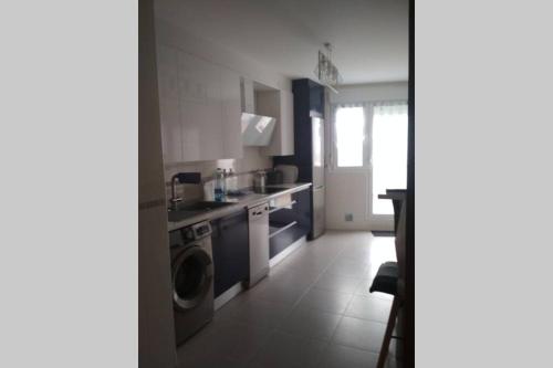 a kitchen with a sink and a washing machine at Atico con vistas únicas. VT-LR-1352 in Entrena
