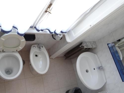 a bathroom with a toilet and a sink at Hotel Amendola Fiera in Milan