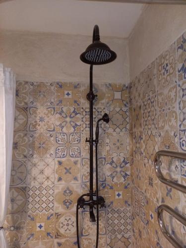 a bathroom with a tile wall with a lamp at Vintage Rooms in Kuldīga