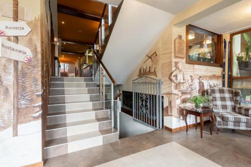 a staircase in a house with a lobby at Hotel Willa Pod Skocznią in Zakopane