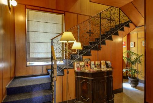 a hallway with a spiral staircase in a house at Hotel Italia in Turin
