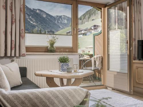 a living room with a table and a window at Brückenhof in Finkenberg